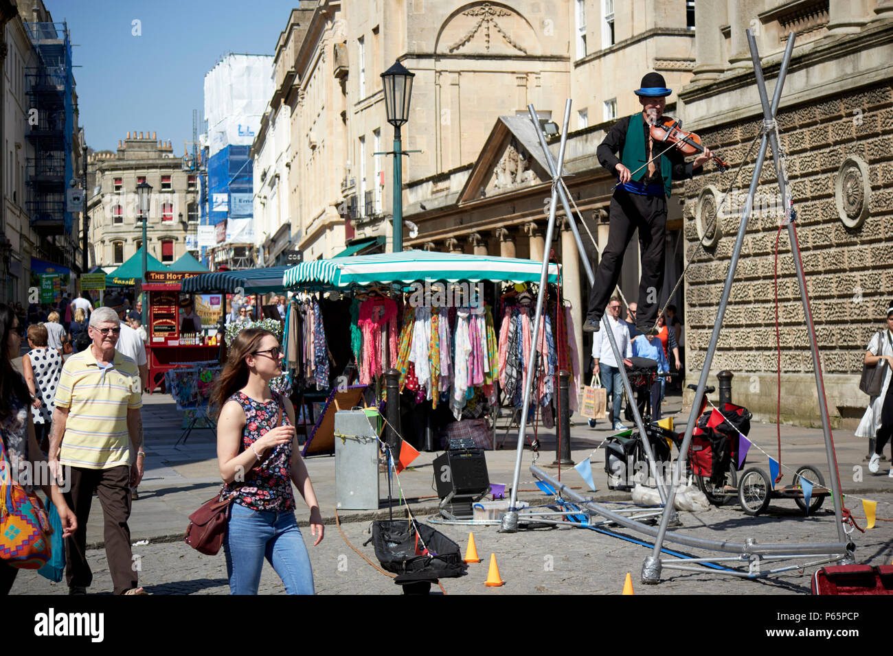 tightrope walker street entertainer on stall street Bath England UK Stock Photo