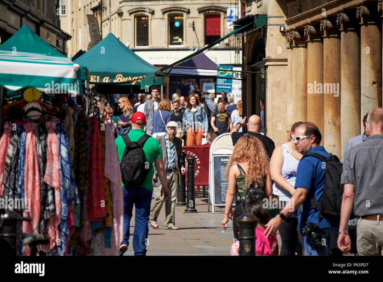shoppers and tourists on busy stall street in the georgian centre of Bath England UK Stock Photo