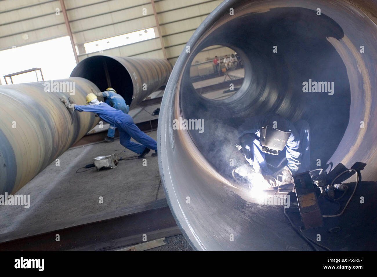 Workers at Hyojong Pipe factory, Doha. Stock Photo