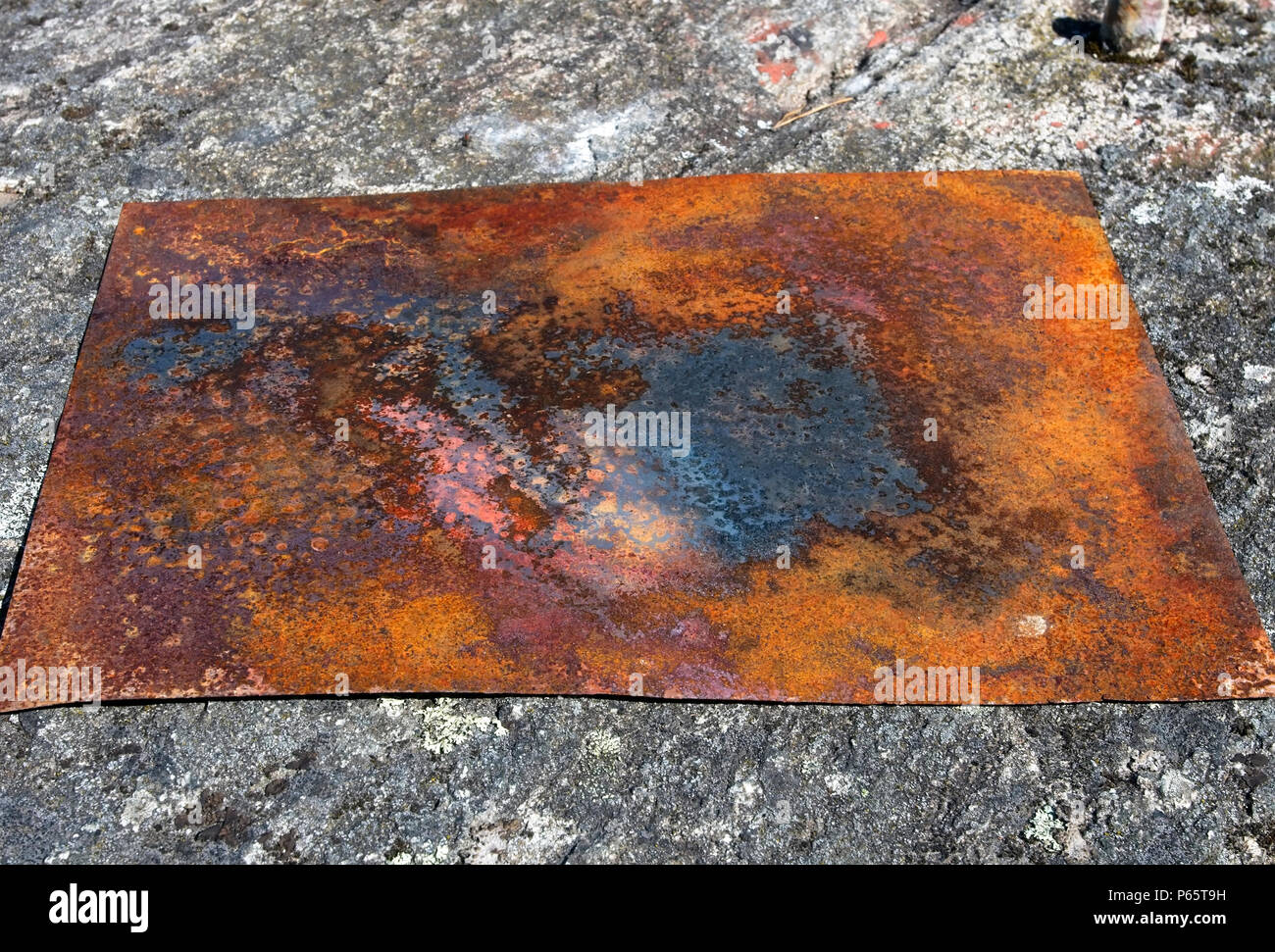 rusty metal plate on ground Stock Photo