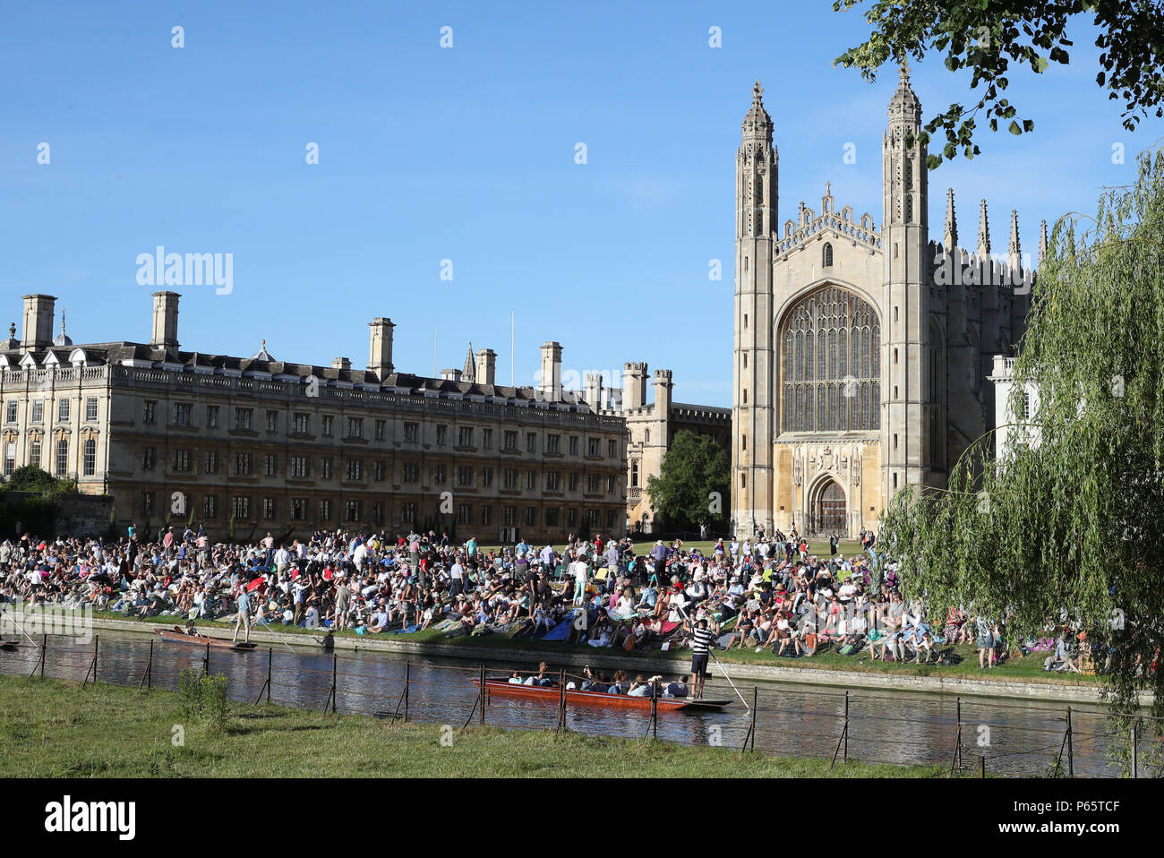 A Punt makes it's way along the river in front of Kings College Chapel at the University of Cambridge. Stock Photo