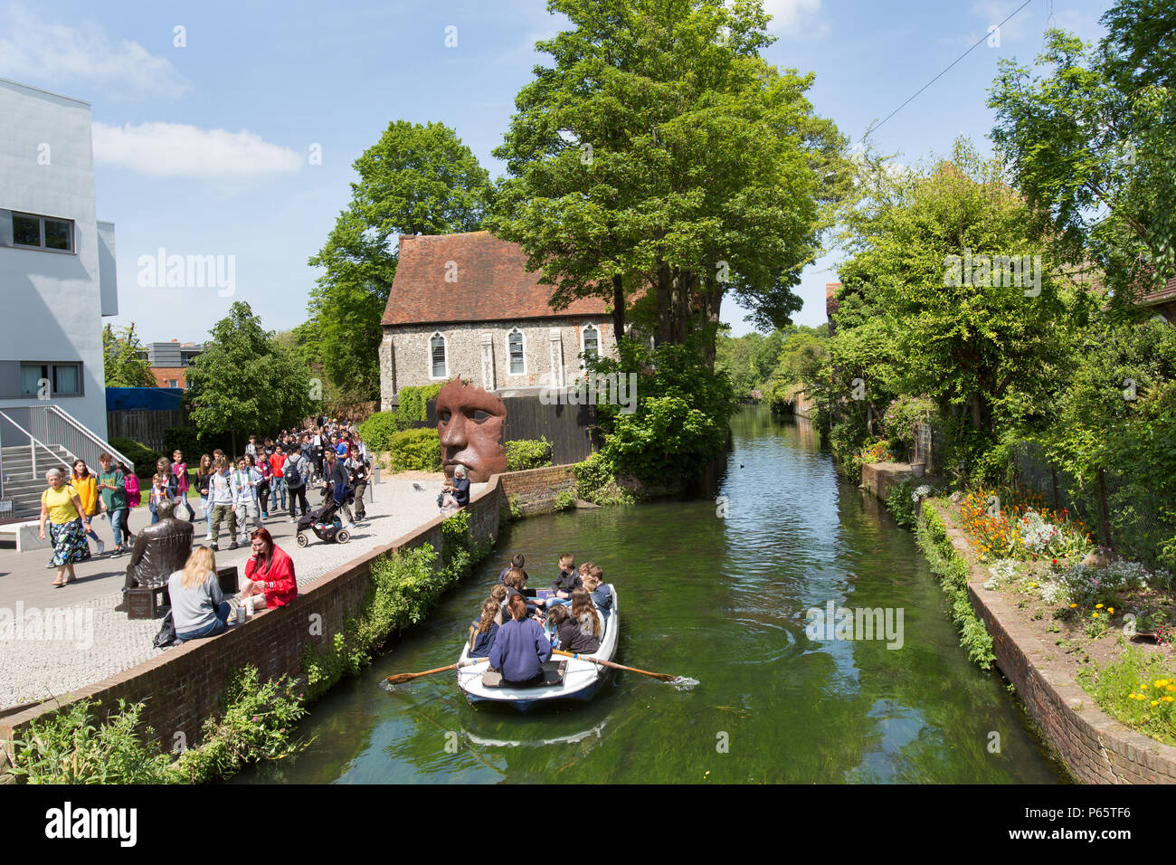 City of Canterbury, England. Picturesque summer view of tourists on a punting tour of the Great Stour, at Canterbury’s The Friars. Stock Photo