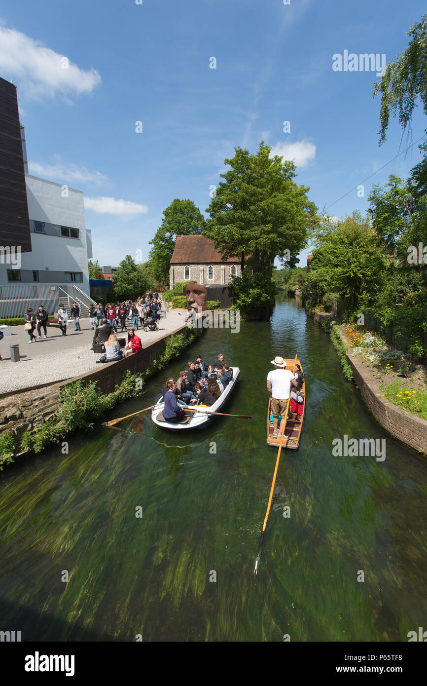 City of Canterbury, England. Picturesque summer view of tourists on a punting tour of the Great Stour, at Canterbury’s The Friars. Stock Photo