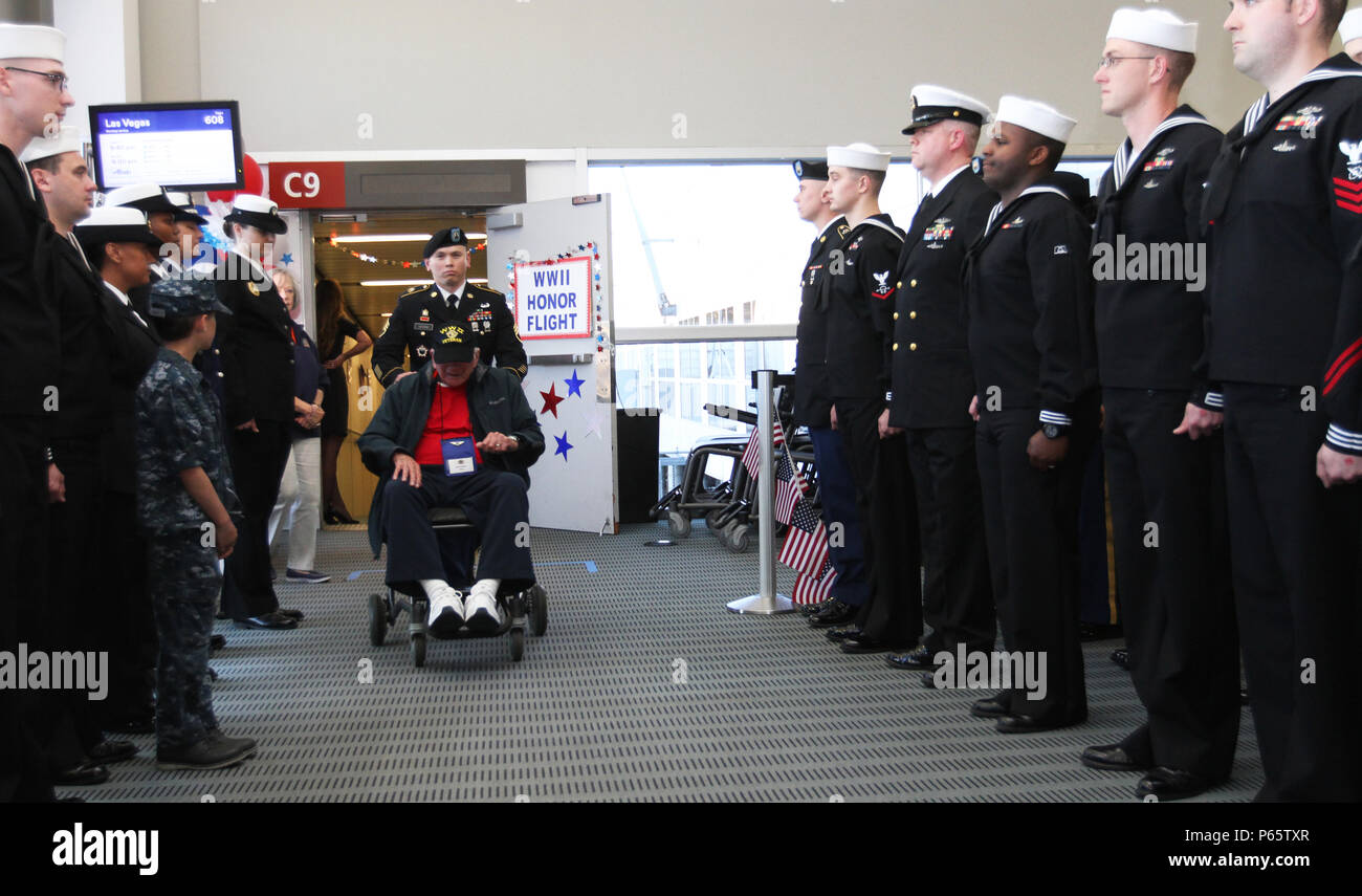 Staff Sgt. Jonathan George, Headquarters and Headquarters Battalion, I Corps, pushes World War II Army veteran David Romero through a formation of service members at the Seattle-Tacoma International Airport as part of an Honor Flight May 9. The veterans were returning from a trip to Washington D.C. to visit memorials honoring their sacrifices. The Honor Flight Network has flown nearly 160,000 veterans to Washington D.C. since 2005. (U.S Army photo by Staff Sgt. Steven Schneider, 5th MPAD) Stock Photo
