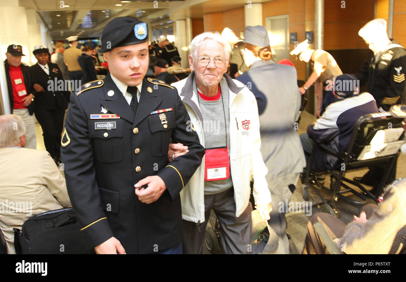 Pfc. John Rodgers, Headquarters and Headquarters Battalion, I Corps, leads World War II Army Air Corps veteran Don Cox through Seattle-Tacoma International Airport as part of an Honor Flight May 9. The veterans were returning from a trip to Washington D.C. to visit memorials honoring their sacrifices. The Honor Flight Network has flown nearly 160,000 veterans to Washington D.C. since 2005. (U.S Army photo by Staff Sgt. Steven Schneider, 5th MPAD) Stock Photo