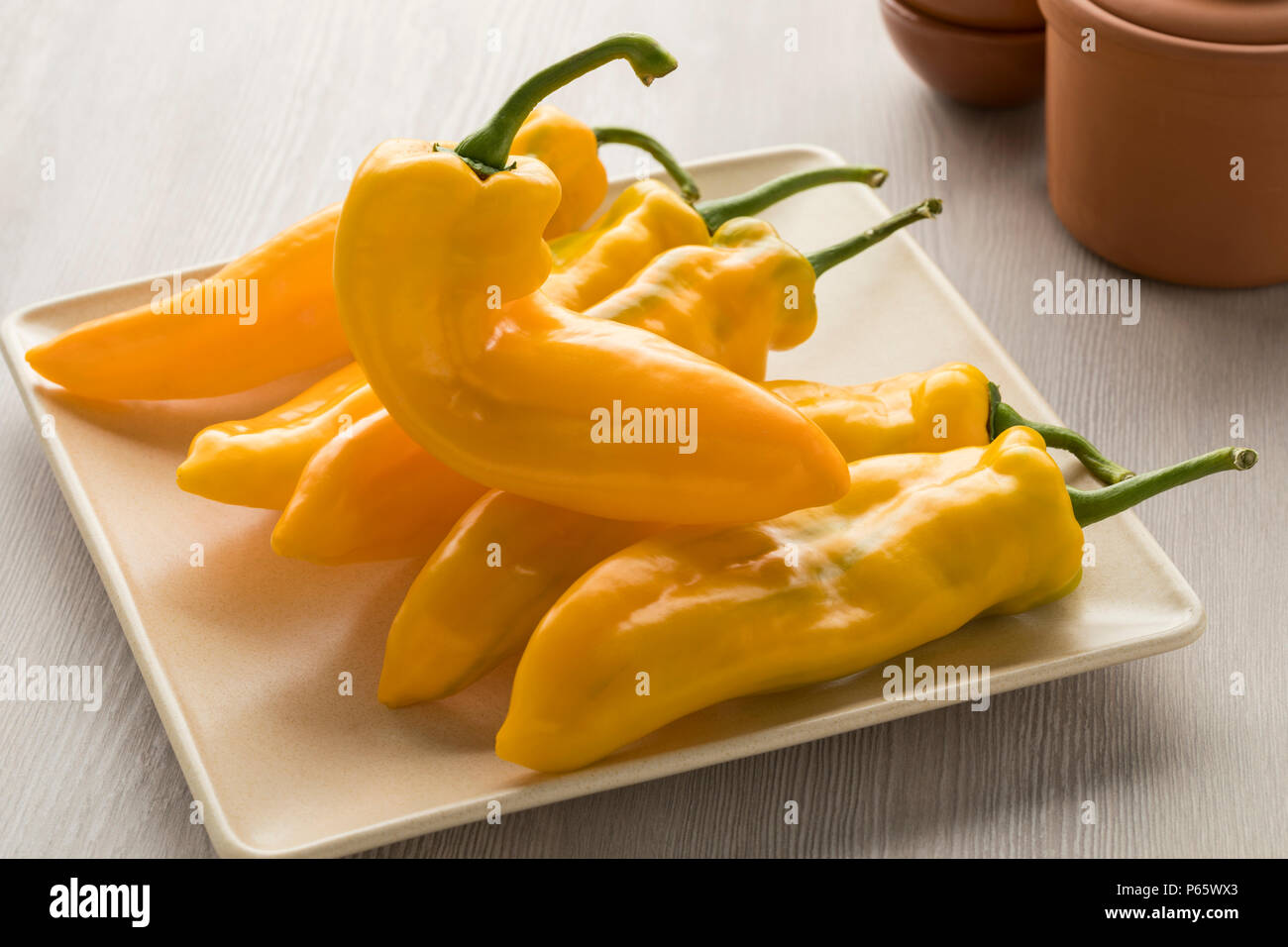 Fresh yellow pointed pepper on a plate Stock Photo