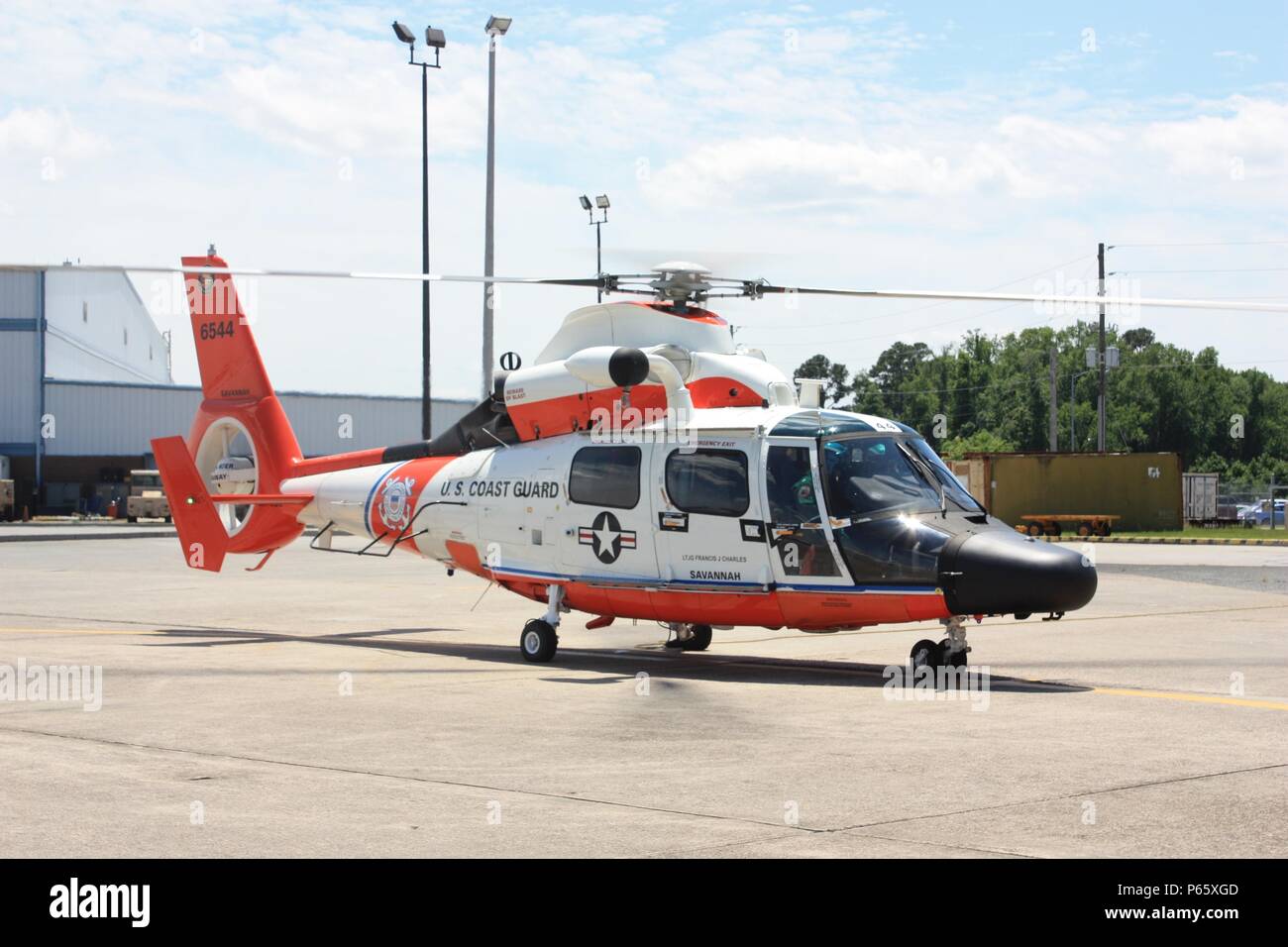 A specially-painted MH-65 Dolphin helicopter was flown to Coast Guard Air Station Savannah, Georgia, May 4, 2016, as part of a unit event highlighting the service’s 100 years of Coast Guard aviation. This helicopter is one of nine to display this particular paint scheme, reminiscent of many early Coast Guard helicopters. U.S. Coast Guard photo by Lt. Trent Meyers Stock Photo