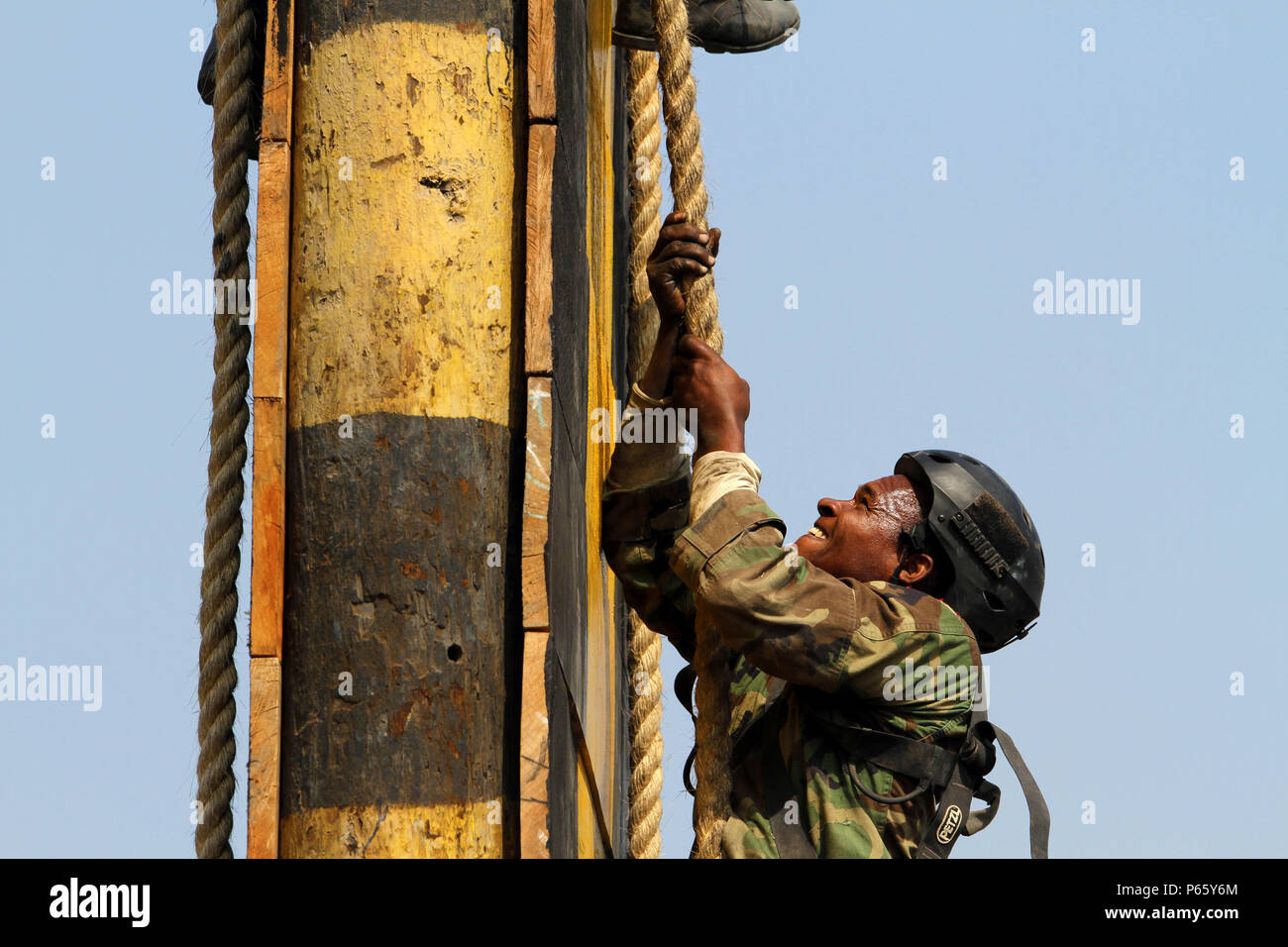 A member of Team Suriname climbs to the top of a rope wall during the ...