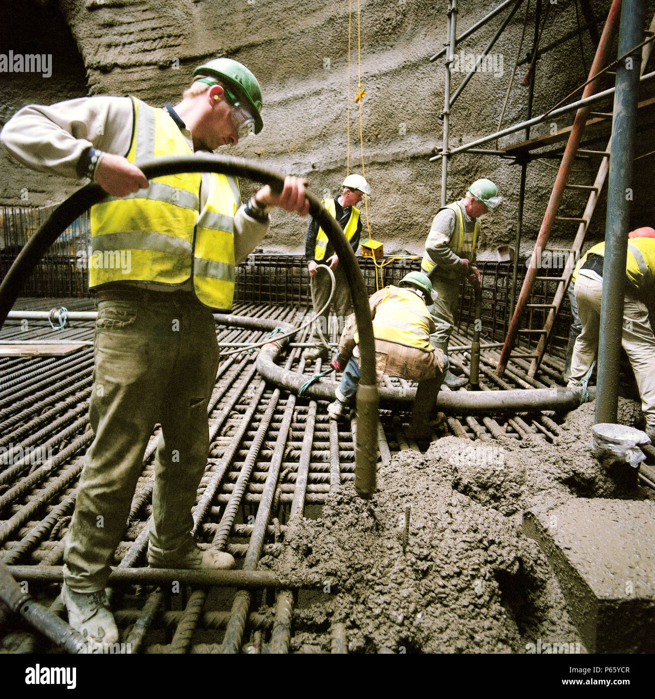 Compacting in situ reinforced concrete using vibrating pokers Stock