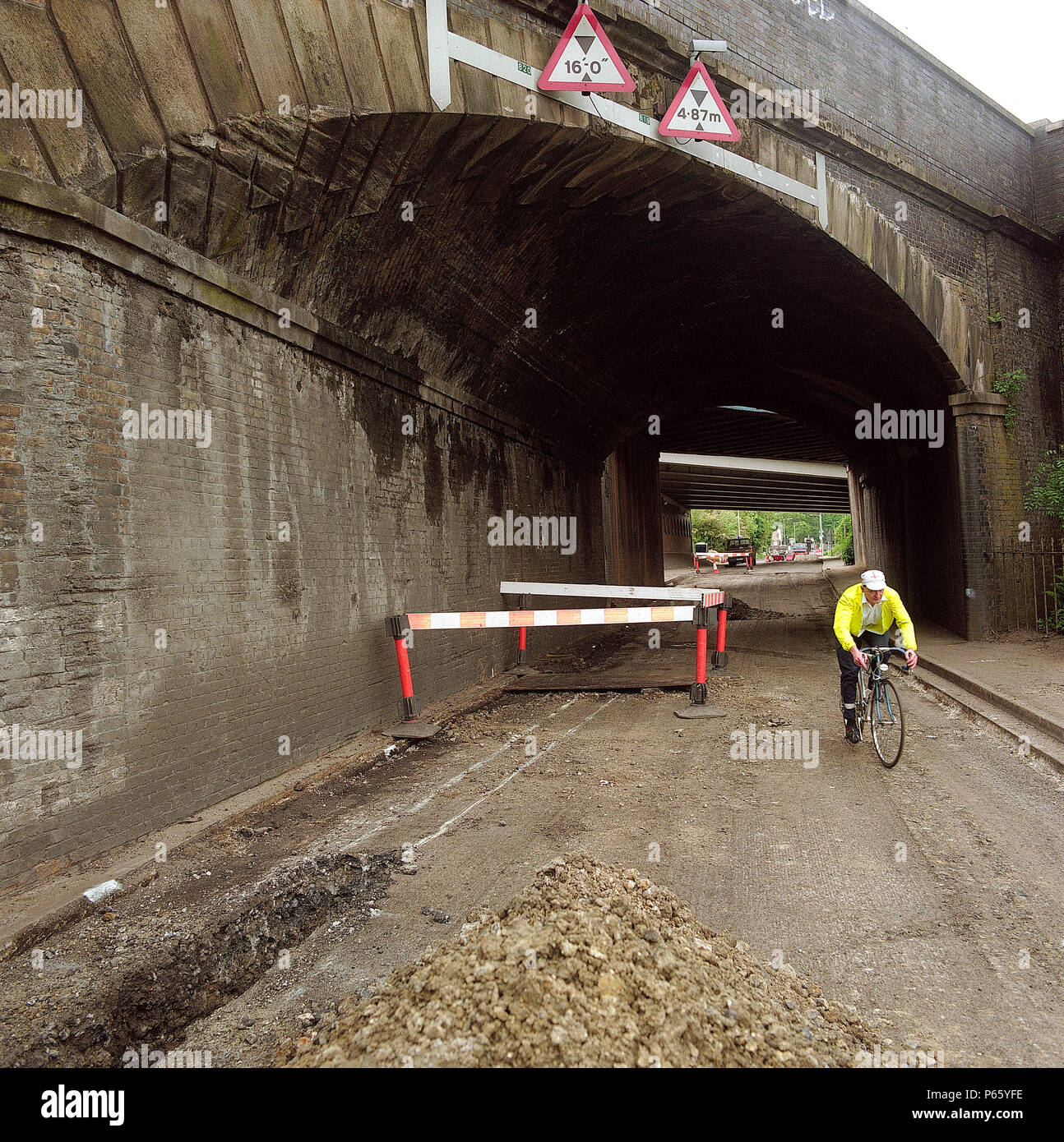 Road about to be resurfaced under railway overbridge. A4251 Hemel Hempstead to Berkhamsted road refurbishment scheme, Hertfordshire, United Kingdom. Stock Photo