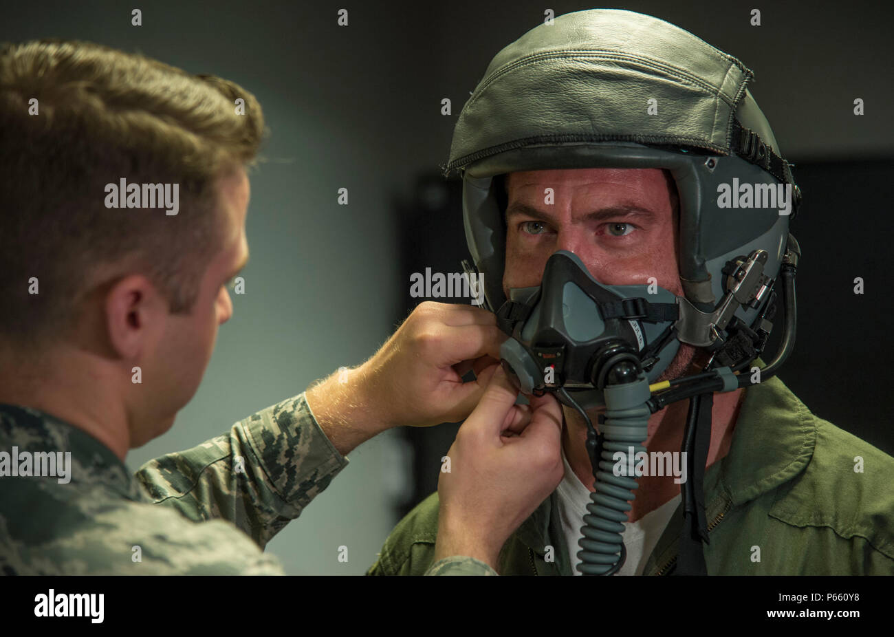 Jesse Palmer, correspondent for ABC’s Good Morning America, has his oxygen mask fitted by an Aircrew Flight Equipment technician at Langley Air Force Base, Va., May 3, 2016. The AFE technicians ensure the mask fits and is free of any seal leaks. (U.S. Air Force photo by Senior Airman Kayla Newman) Stock Photo