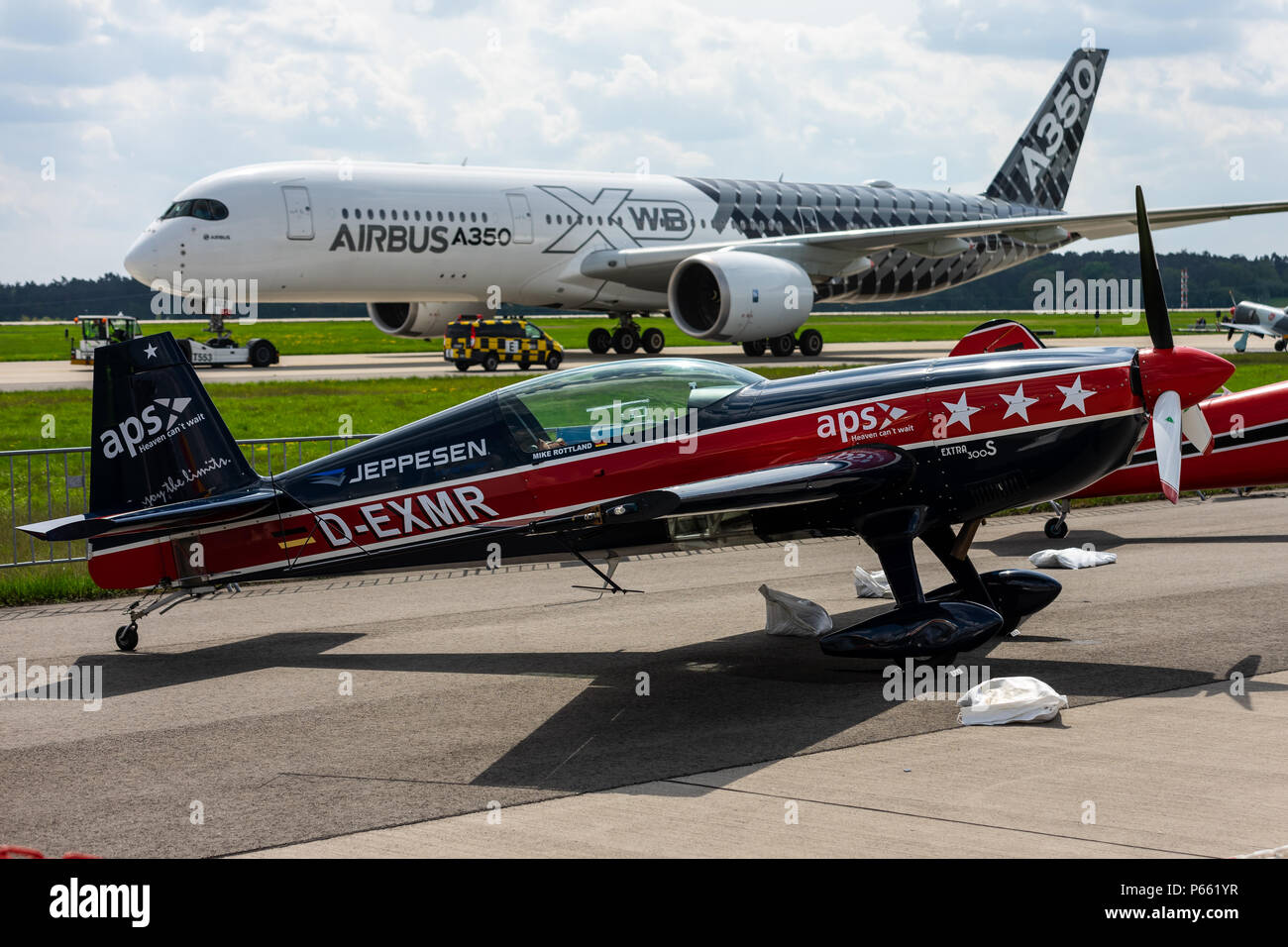 The twoseat aerobatic monoplane Extra EA300S (foreground) and the