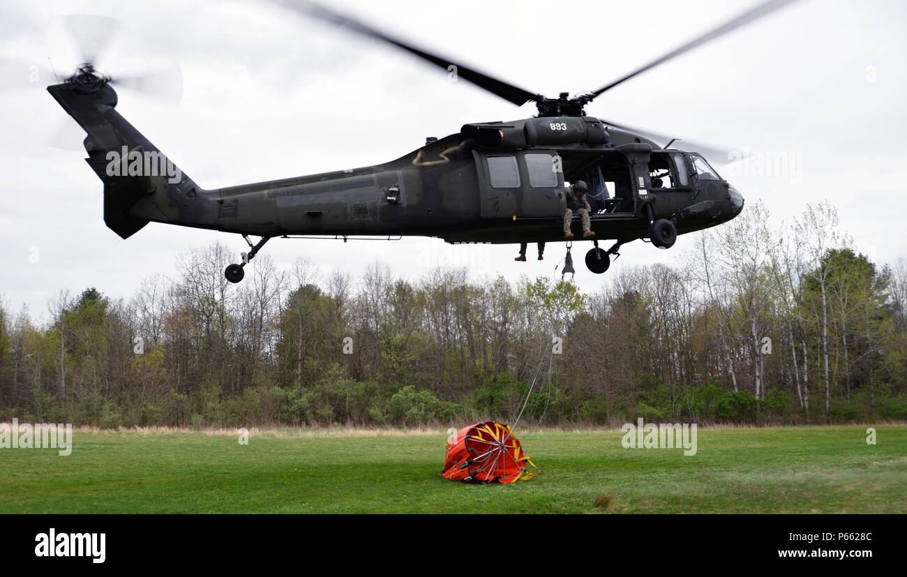 A New York Army National Guard UH-60 Blackhawk based in Latham, N.Y. hovers in place while doing swift load and drop water bucket training at Round Lake N.Y.on Thursday May 5, 2016. The National Guard conducts this training annually to practice flying with that much additional weight under the aircraft. The Soldiers are part of the 42nd Combat Aviation Brigade. (U.S. Army National Guard Photo by Capt. Jean Marie Kratzer/ Released) Stock Photo