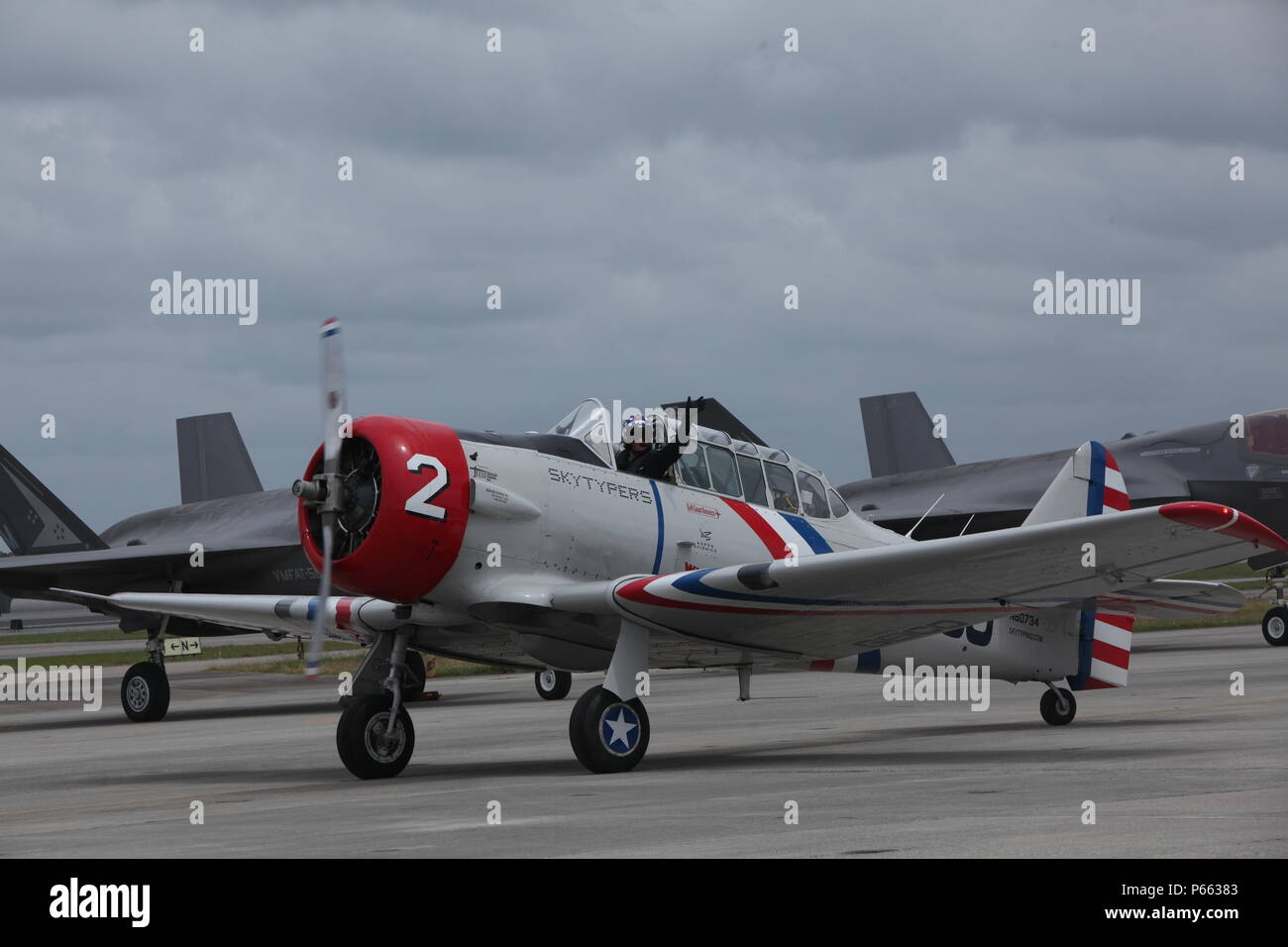 A member of the GEICO Skytypers cruises the flight line after an aerbatic performance at the 2016 Marine Corps Air Station Cherry Point Air Show – “Celebrating 75 Years” at MCAS Cherry Point, N.C., May 1, 2016.  The GEICO Skytypers’ flight squadron of six SNJ-2 aircraft perform precision flight maneuvers. The team of vintage World War II aircraft is known for skytyping the process of emitting biodegradable vapor in a dot matrix pattern, creating a billboard in the sky. This year’s air show celebrated MCAS Cherry Point and 2nd Marine Aircraft Wing’s 75th anniversary and featured 40 static displ Stock Photo