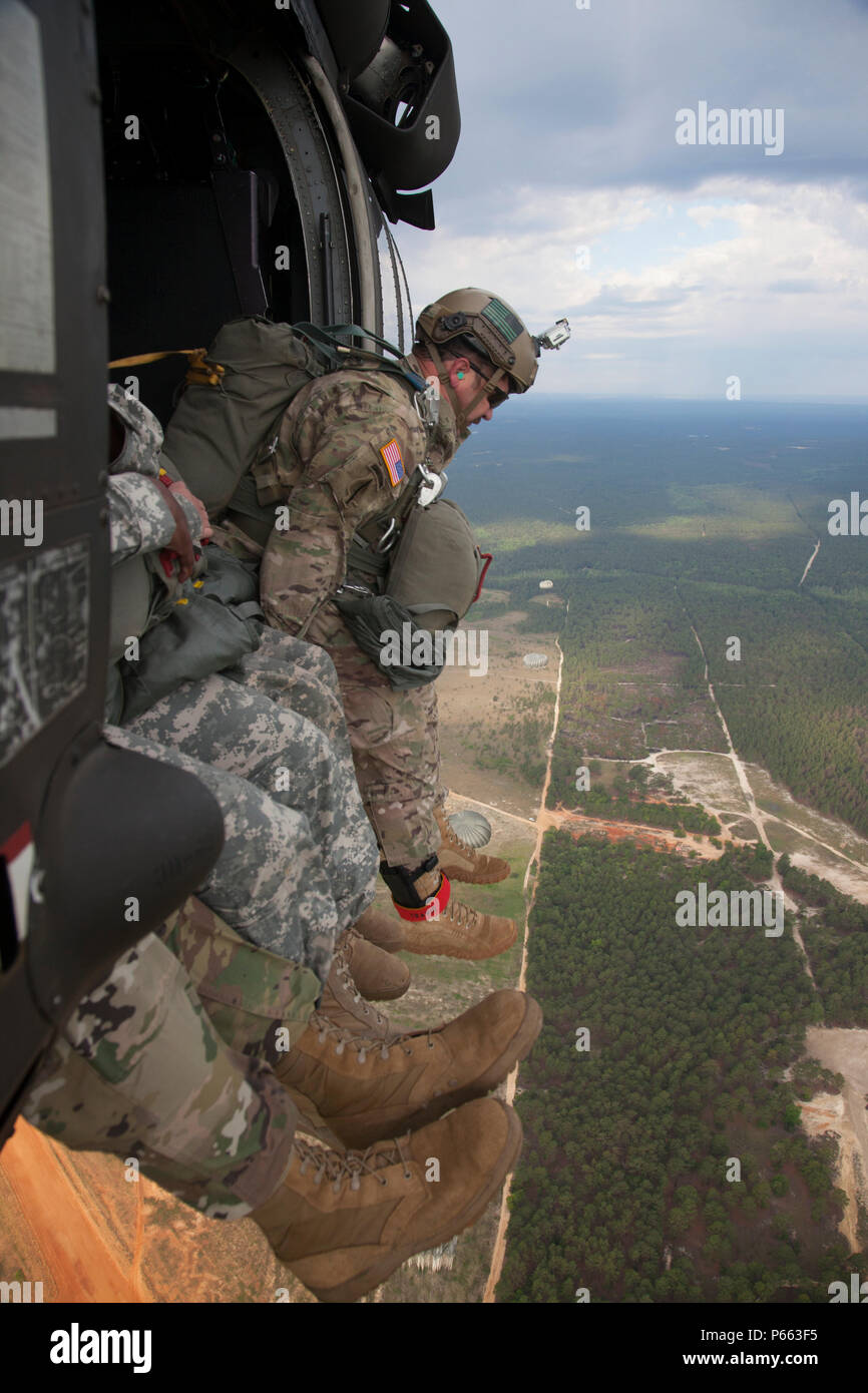 A U.S. Army Paratrooper jumps from a UH60 Blackhawk over the St. Mere