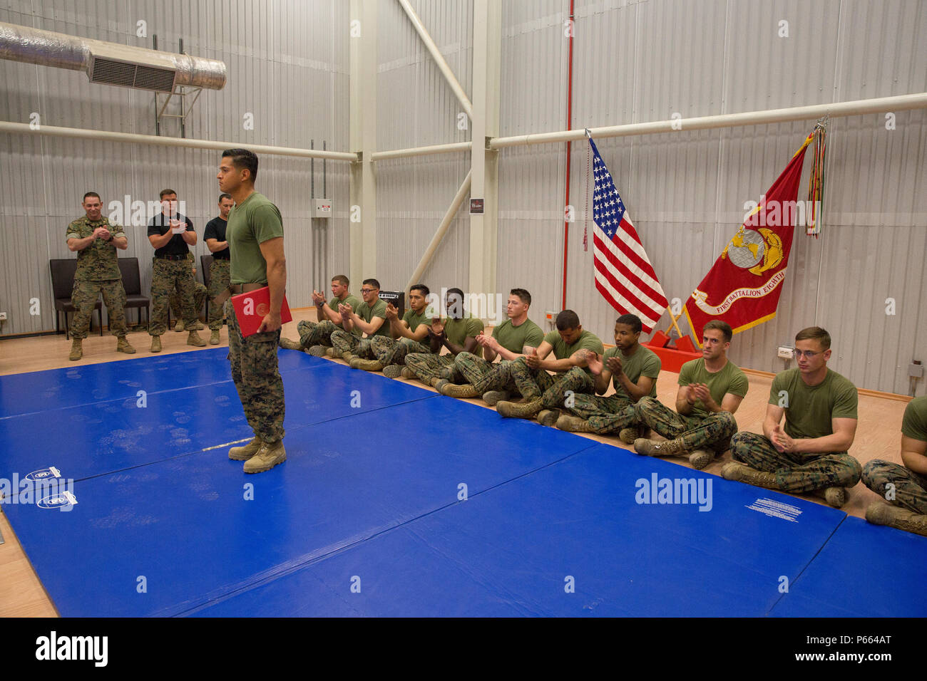 U.S. Marine Corps Sgt. Antonio Luna, a squad leader with Black Sea Rotational Force, is recognized by Marines and sailors for graduating as the honor graduate of his Marine Martial Arts Instructor Course, aboard Mihail Kognalniceanu Air Base, Romania, April 22, 2016. These graduates spent three weeks enduring physical training sessions, learning how to correctly give hip-pocket classes, and how to properly teach techniques of all belt levels of the Marine Corps Martial-Arts Program. (U.S. Marine Corps photo by Cpl. Kelly L. Street, 2D MARDIV COMCAM/Released) Stock Photo