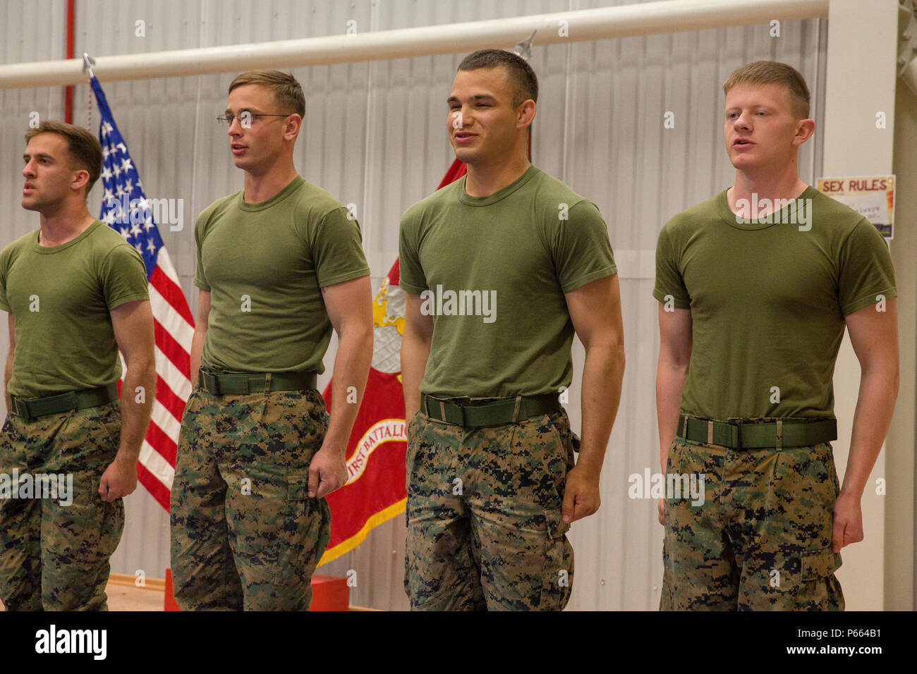 Newly graduated U.S. Marine Martial Arts Instructors with Black Sea Rotational Force sing the Marines' Hymn and recite the 'The Warrior Creed' at the conclusion of their graduation ceremony for class 155-16, Mihail Kognalniceanu Air Base, Romania, April 22, 2016. MAI class 155-16 is the first Marine Corps Martial Arts Instructor Course to be held RF 16.1  Mihail Kognalniceanu Air Base, Romania. (U.S. Marine Corps photo by Cpl. Kelly L. Street, 2D MARDIV COMCAM/Released) Stock Photo