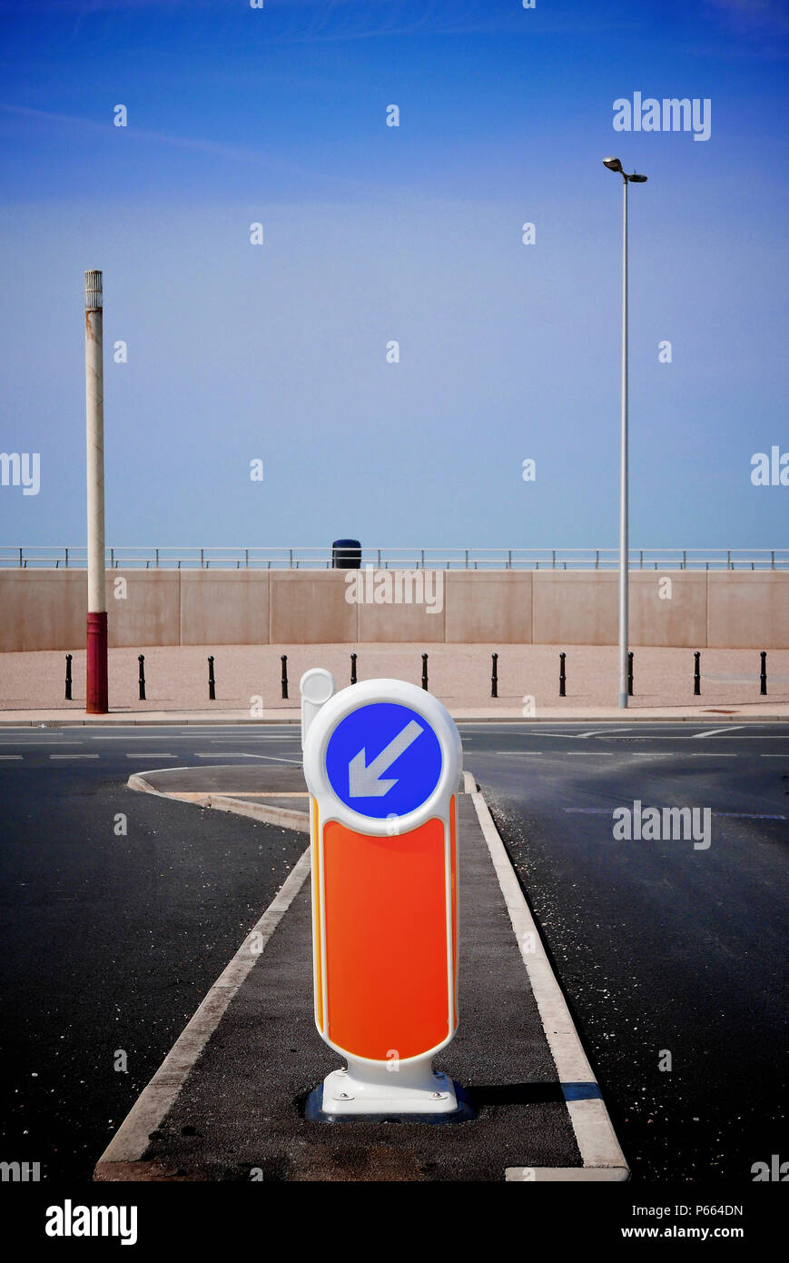 Keep left sign at road junction in front of concrete wall,Cleveleys,UK Stock Photo