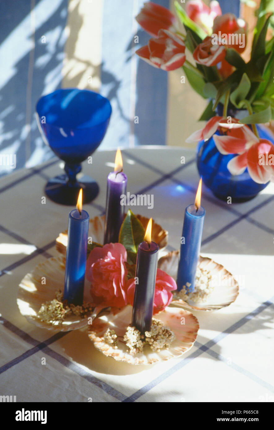 Close-up of lighted blue candels in seashells used as candle holders Stock Photo