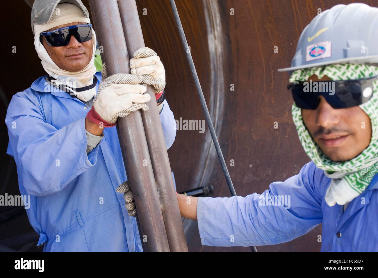 Workers at Hyojong Pipe factory, Doha. Stock Photo