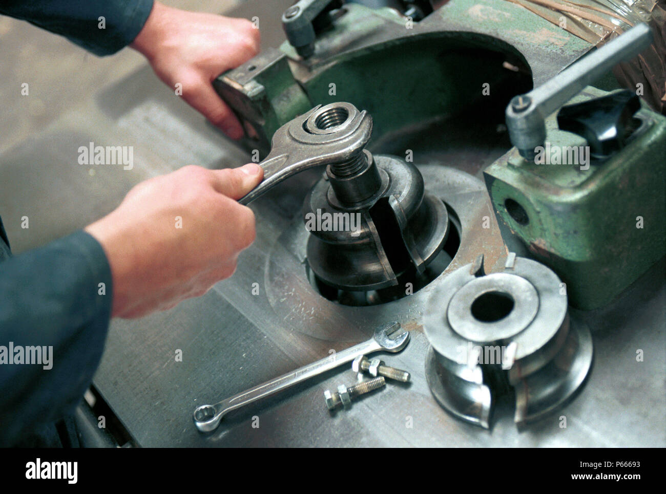 Woodmachining. Changing Tooling on a spindle moulder. Stock Photo