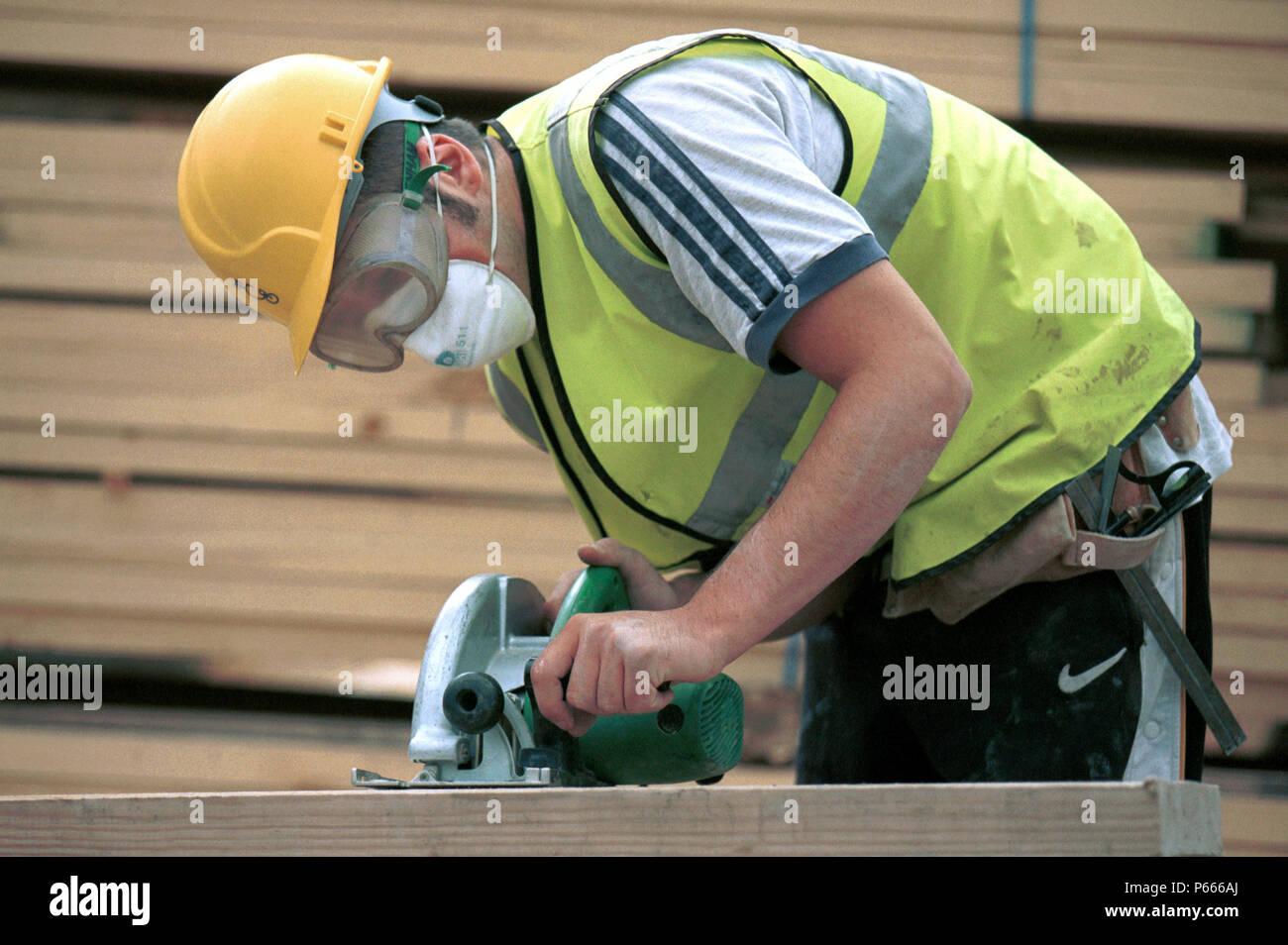 Carpentry and Joinery. Operating a circular portable saw Stock Photo