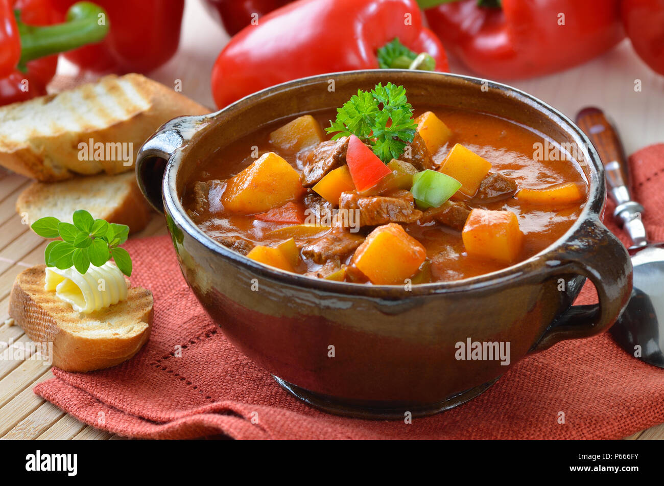 Typical Hungarian goulash soup with baguette Stock Photo