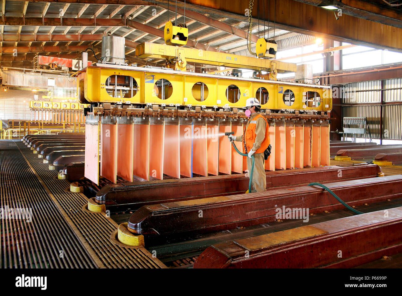 Worker Cleaning Copper Cathodes In Escondidas Electro Winning Shed