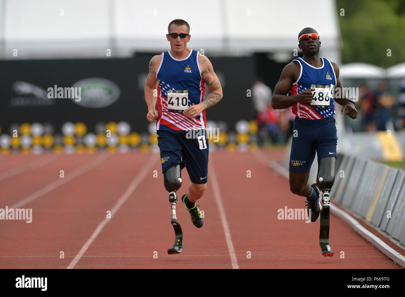 Allan Armstrong, left, and William Reynolds of team US run during the 100  meter men's track at the 2016 Invictus Games at the ESPN Wide World of  Sports Complex, Orlando, Fla., May