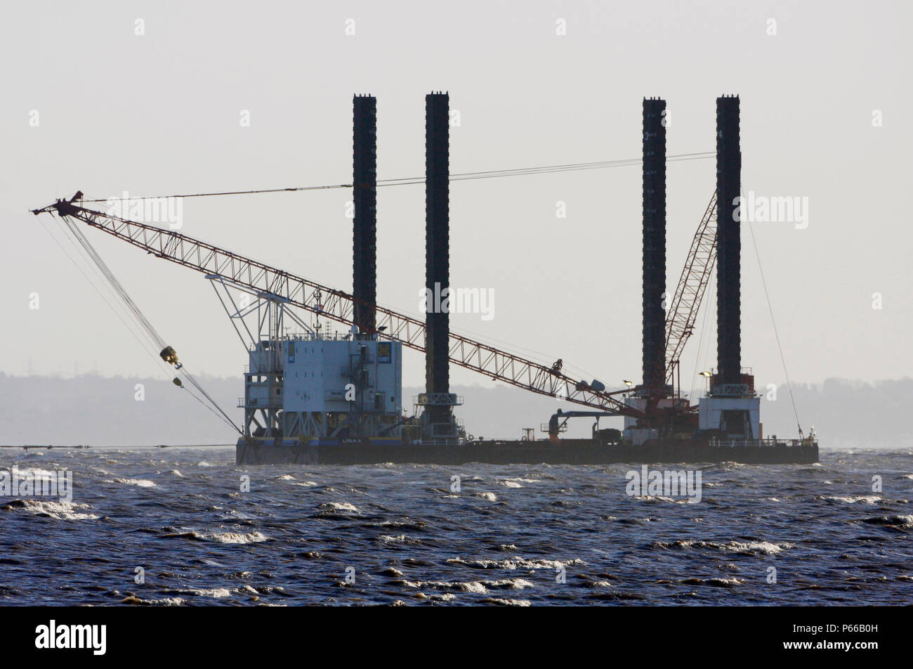 Barge installing offshore wind turbines, Talacre Flint, RSPB Reserve, Dee Estuary, Wales, UK Stock Photo