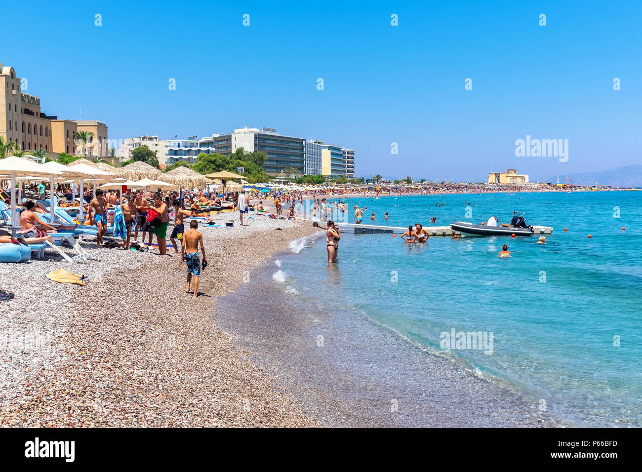 People relaxing and sunbathing at Elli Beach, the main beach of Rhodes Town. Greece Stock Photo