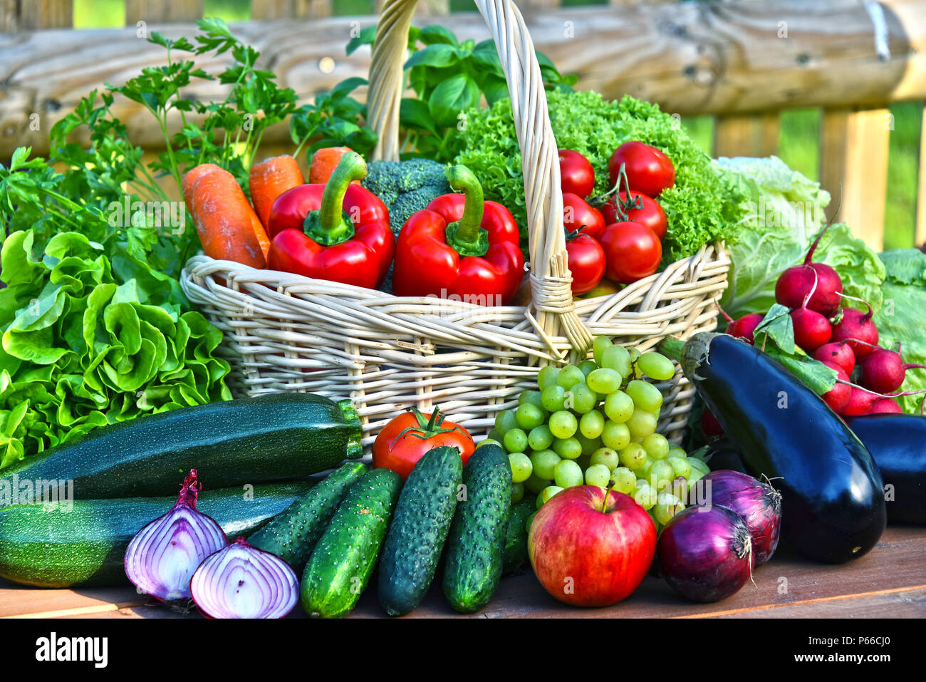 Variety of fresh organic vegetables in wicker basket Stock Photo - Alamy