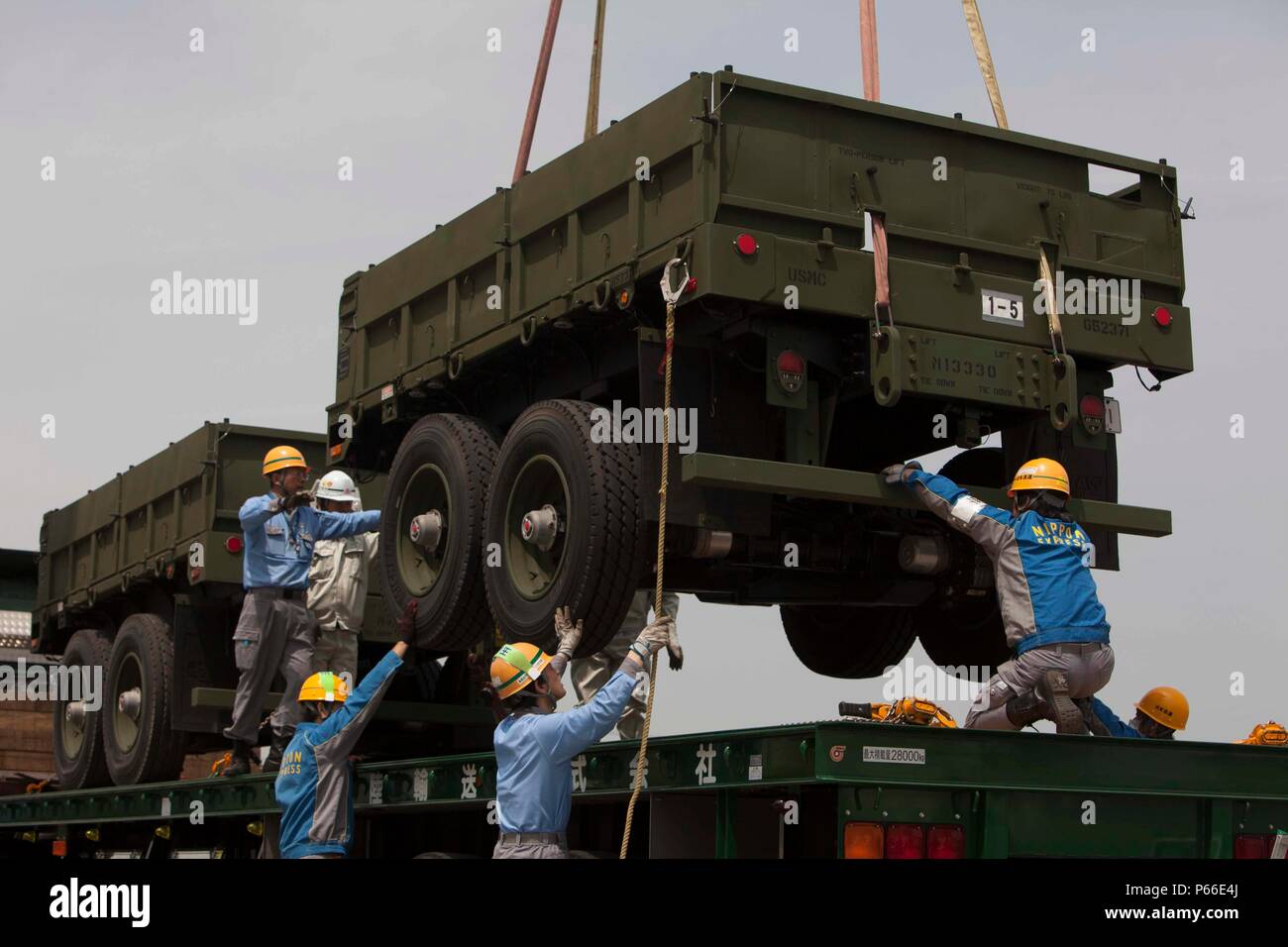 SENDAI, Japan – Japanese embarkation contractors unload cargo for ...