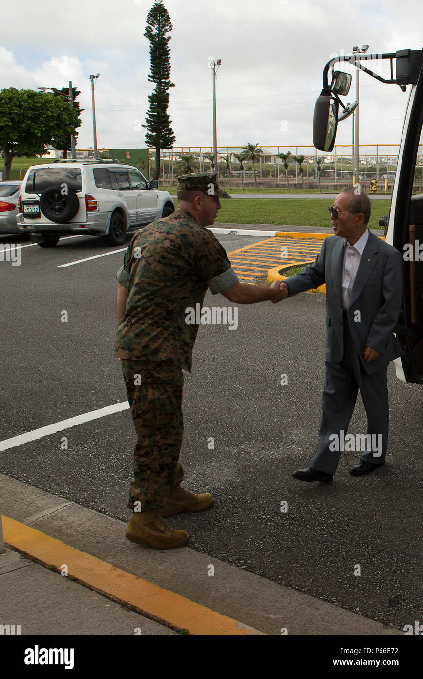 Lt. Col. Robert Sweginnis, left, and Hisashi Nagano shake hands May 9 on Marine Corps Air Station Futenma, Okinawa, Japan. Members of the Iwakuni Chamber of Commerce and Choguko Shikoku Defense Bureau visited MCAS Futenma and Camp Schwab to learn about the missions and roles of the two bases. The visit was part of an effort to continue good working relationships with host nation partners during and after the relocation of the KC-130J Super Hercules units from Okinawa to Iwakuni, Japan. Maintaining positive relationships with Japanese partners allow Marine Corps Installations Pacific to presenc Stock Photo