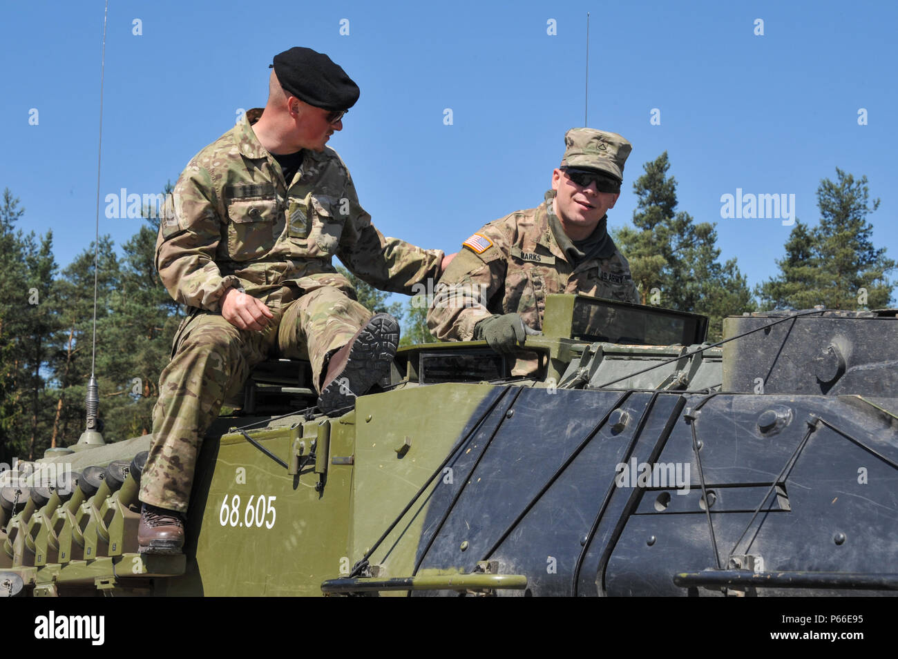 Soldiers from all nations participating in the Strong Europe Tank Challenge (SETC) inspect each others equiment May 08, 2016 at Grafenwoehr Training Area, Germany. The SETC is co-hosted by U.S. Army Europe and the German Bundeswehr May 10-13, 2016. The competition is designed to foster military partnership while promoting NATO interoperability. Seven platoons from six NATO nations are competing in SETC - the first multinational tank challenge at Grafenwoehr in 25 years. For more photos, videos and stories from the Strong Europe Tank Challenge, go to http://www.eur.army.mil/tankchallenge/ (U.S. Stock Photo