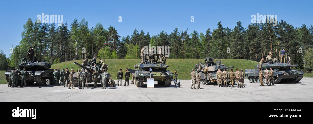 Soldiers from all nations participating in the Strong Europe Tank Challenge (SETC) inspect each others equiment May 08, 2016 at Grafenwoehr Training Area, Germany. The SETC is co-hosted by U.S. Army Europe and the German Bundeswehr May 10-13, 2016. The competition is designed to foster military partnership while promoting NATO interoperability. Seven platoons from six NATO nations are competing in SETC - the first multinational tank challenge at Grafenwoehr in 25 years. For more photos, videos and stories from the Strong Europe Tank Challenge, go to http://www.eur.army.mil/tankchallenge/ (U.S. Stock Photo