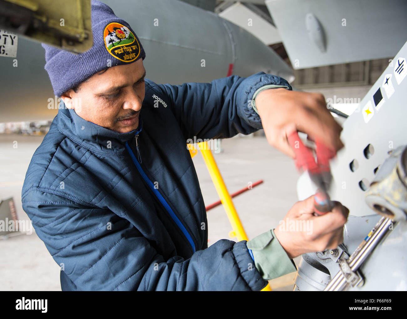 Sgt. D. Thaku, a maintenance airmen from the Indian Air Force (IAF), 14  Fighter Squadron, Ambala Air Base, India, works to change a shock absorber  on a Jaguar attack jet aircraft April