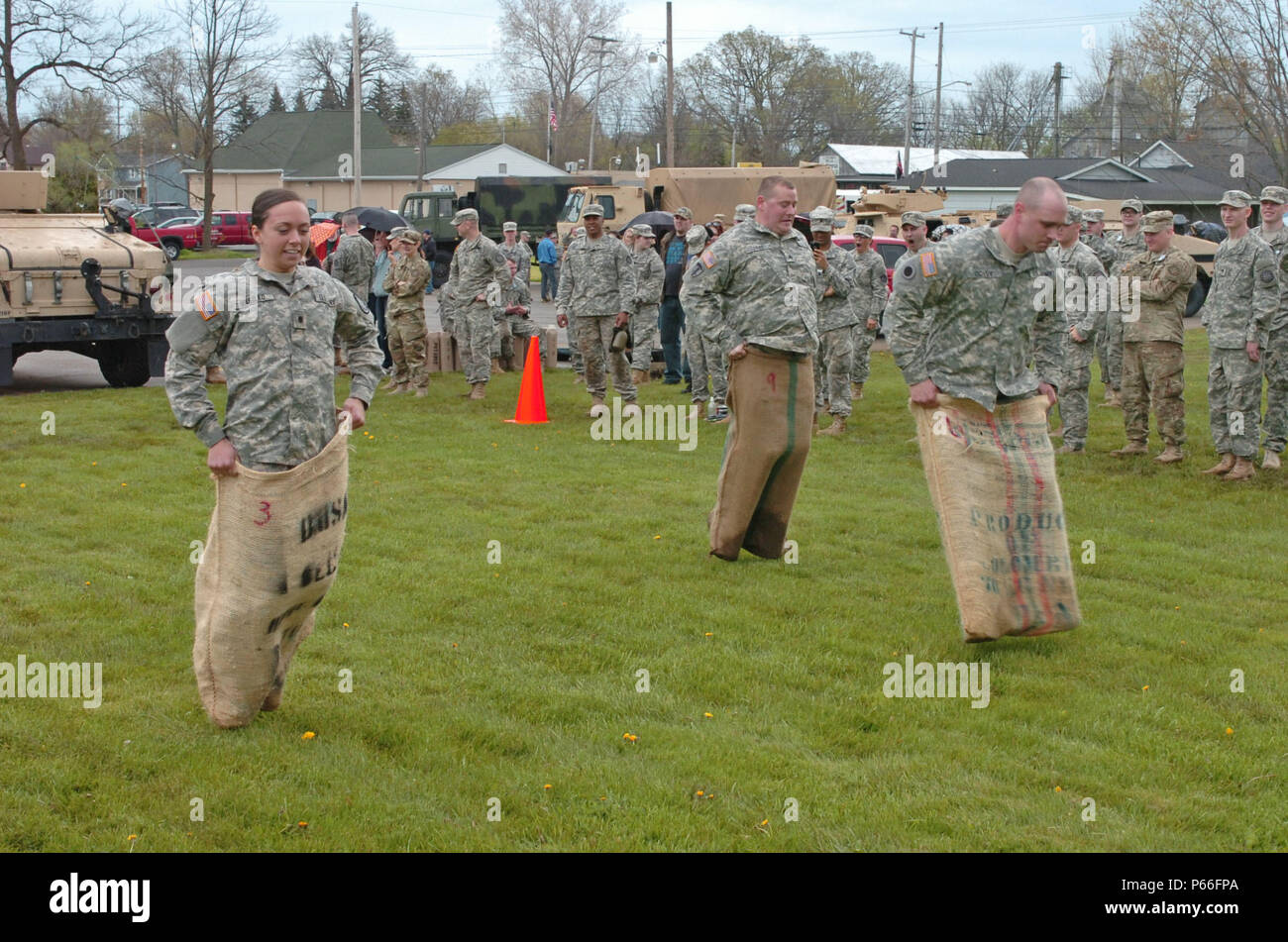 Soldiers of the 144th Military Police Company, 210th MP Battalion, 177th MP Brigade, Michigan National Guard, compete in the Sackman's race portion of the Blackhats' Last Charge held in Corunna, Mich., May 7, 2016. The Blackhats' Last Charge is a competition in which Soldiers compete in three-person teams against each other through a three-mile road march and a series of physical team events that include the Sackman's race, Meal Ready to Eat sit-ups, tow bar carries, tow bar squats, an arm chair carry, team triangle push-ups, burpees, and a HMMWV push. The 144th MP Co. is being divested as par Stock Photo