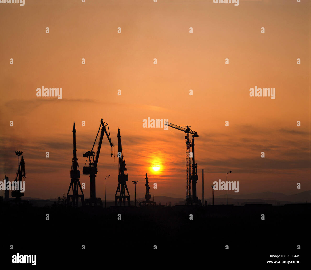 Harbour loading docks at sunset Stock Photo - Alamy