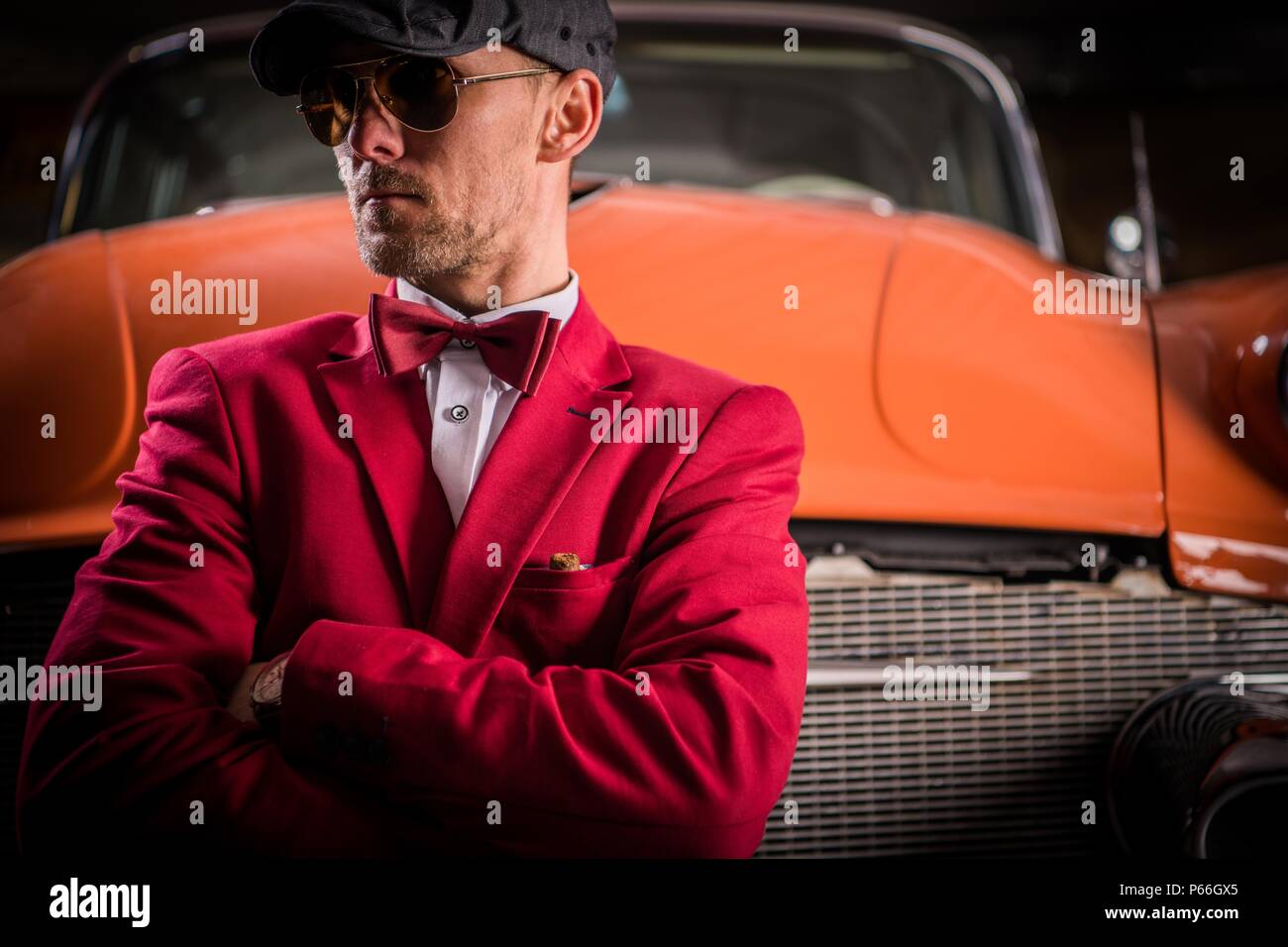 Classic Vehicles Collector. Elegant Caucasian Men Awaiting Classic Cars Auction. Stock Photo