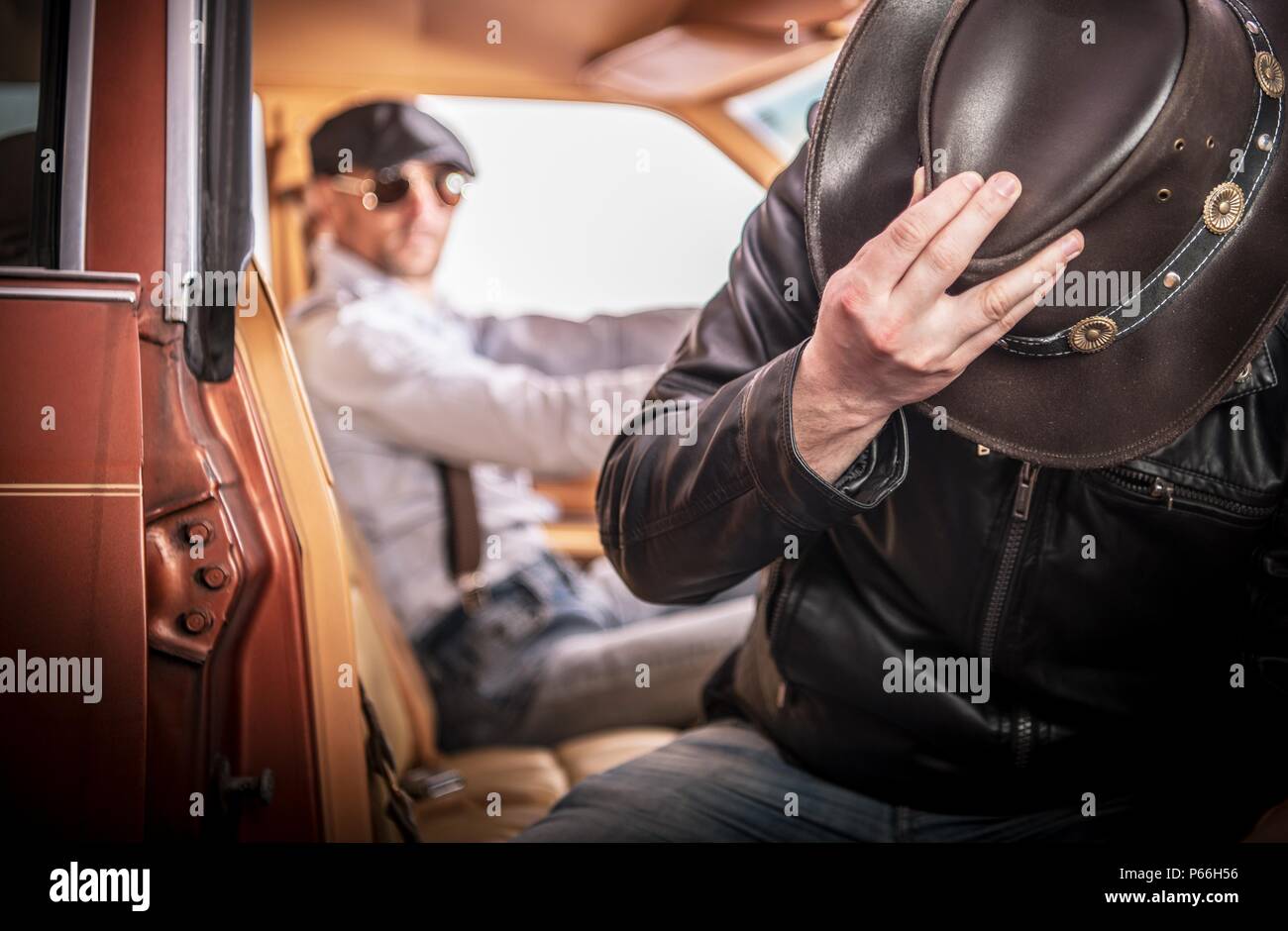 Picking Up Strange and Drunk Hitchhiker in Cowboy Hat. Transportation Theme. Stock Photo