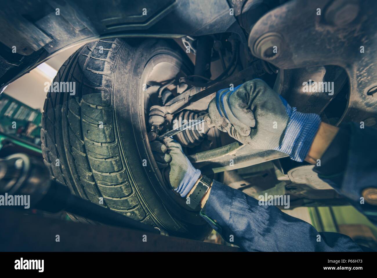Checking Steering Joints For Wear. Car Mechanic at Work. Auto Service Maintenance. Stock Photo