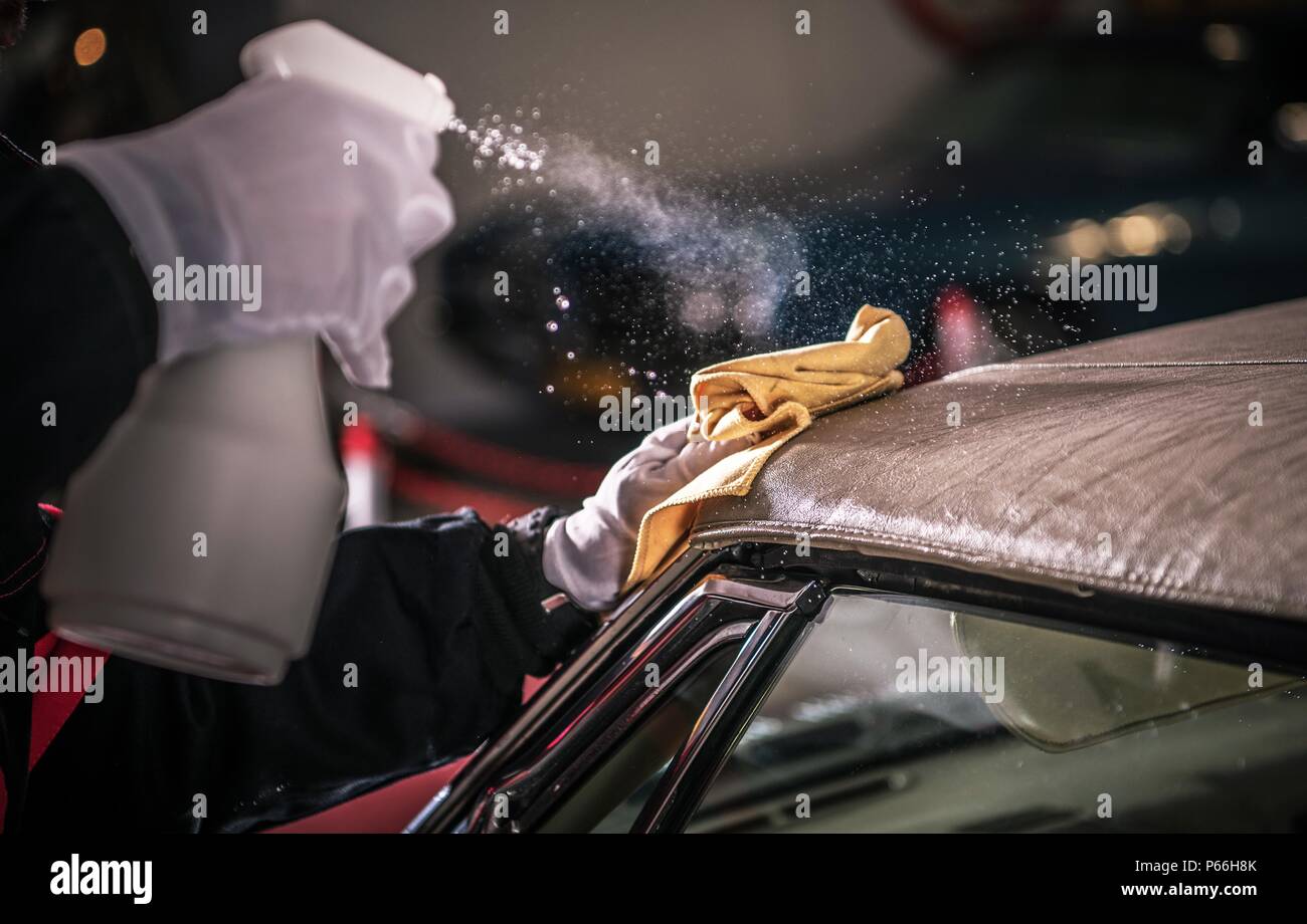 Men Spraying Vinyl Protectant For the Convertible Car Soft Roof. Stock Photo