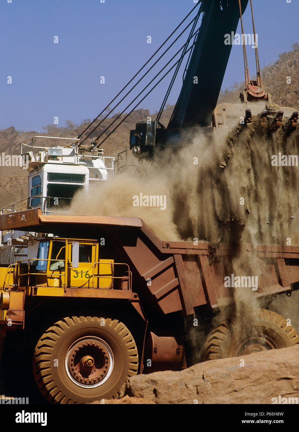 Loading rigid dumper truck at Mt Tom Price Rio Tinto iron ore mine, Australia. Stock Photo