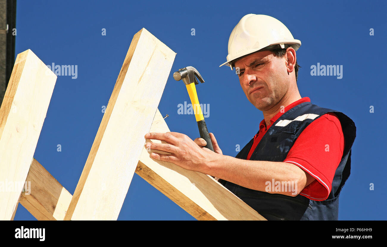 Construction Worker Hammering Nail Into Roof Stock Photo Alamy