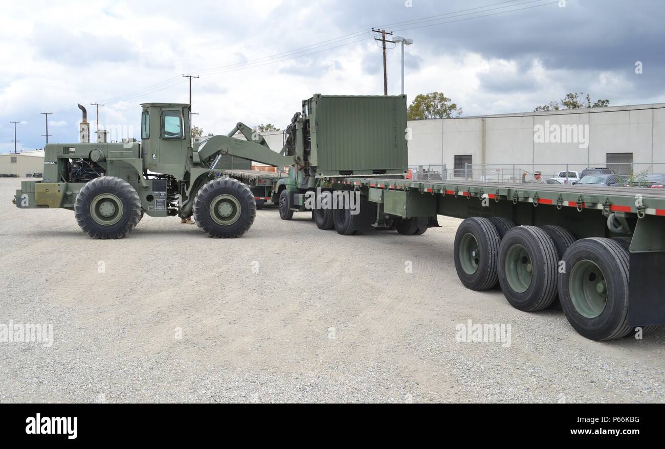 A fork lift loads a Quadcon container on to a M872 Series 40foot, 34