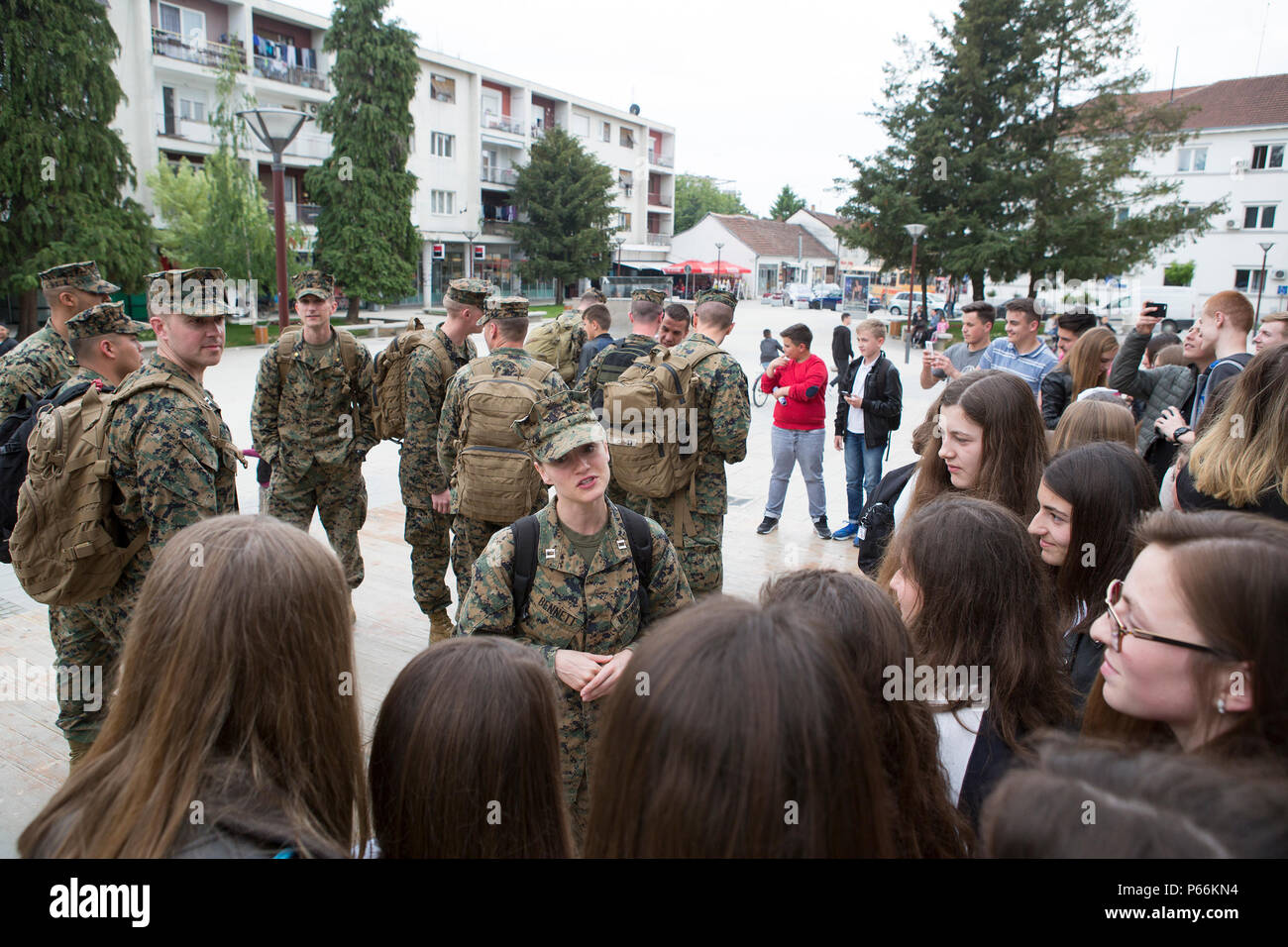 Capt. Brittney Bennett, a judge advocate with 3rd Civil Affairs Group, Force Headquarters Group, Marine Forces Reserve, speaks with young girls while participating in the program called American Corners, where they have the opportunity to teach local children about American culture and the Marine Corps during exercise Platinum Wolf 2016, in Bujanovac, Serbia, May 11, 2016. The Marines visited two American Corners sites in Bujanovac and Vranje during the exercise. The program is sponsored by the U.S. embassy and a local host institution; it aims to reinforce intercultural exchange and friendshi Stock Photo