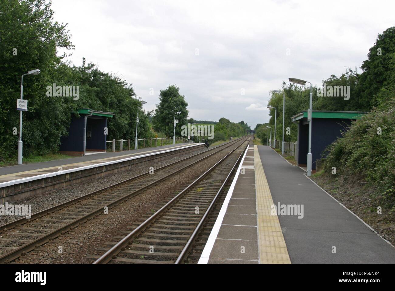 General platform view at Wooton Wawen station, Warwickshire, showing platform lighting and waiting shelters. 2007 Stock Photo