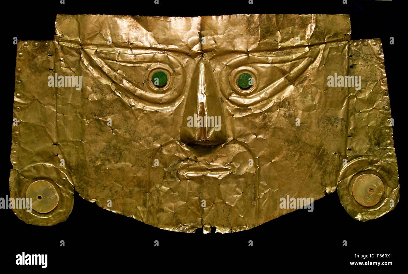 Pre-Columbian art: Chimu gold burial mask, with shell ear-plugs and dark green stone eyes, from northern Peru, 1100 - 1400 AD. This mask would have been placed on the face of a mummy. Stock Photo