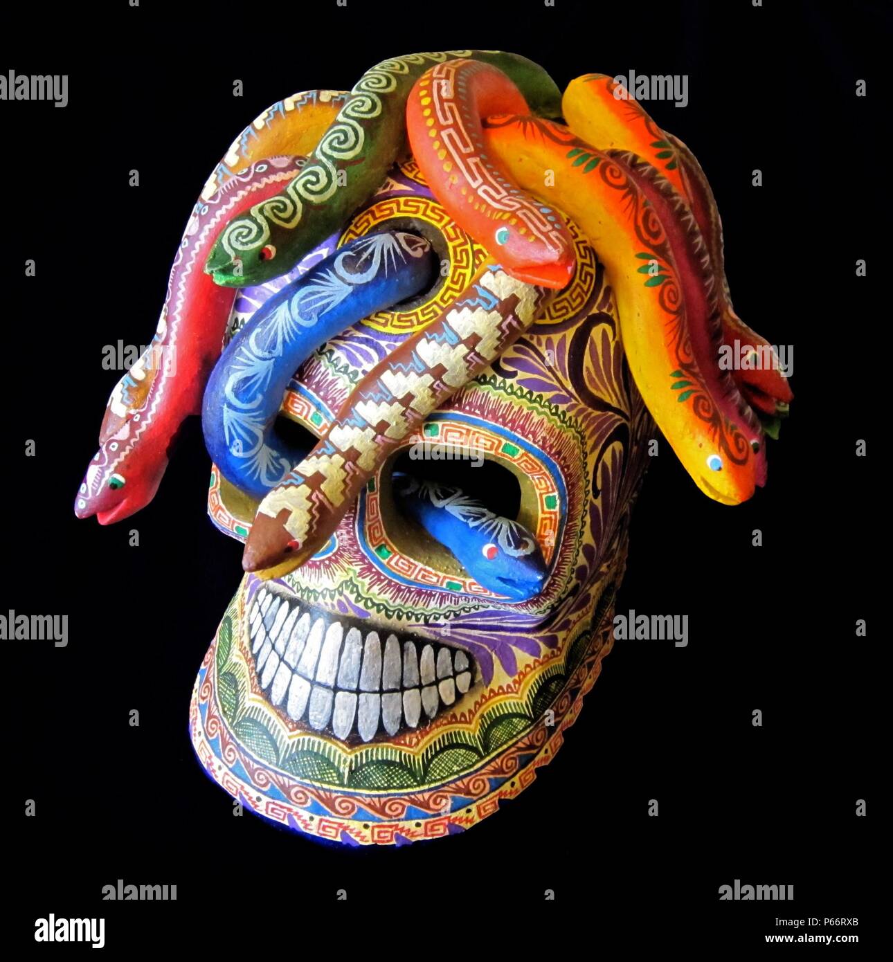 Mexican Puebla Medusa skull, by Saul Montesinos, 2010. Fourteen coloured snakes emerge from holes in the top of the skull and another from an eye socket. Ht: 6 in; 15 cm. Stock Photo